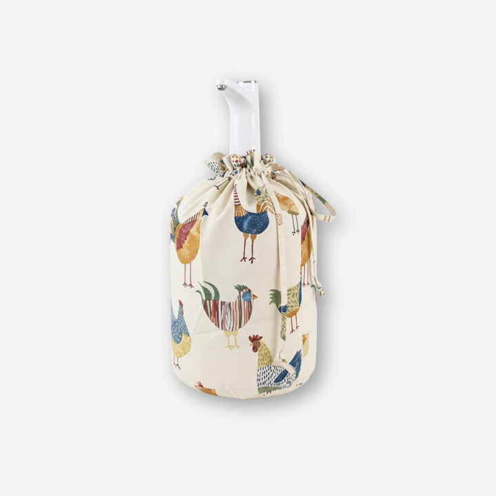 A fabric drawstring bag with a white handle, featuring a colorful pattern of stylized chickens on an off-white background, shown against a light gray studio backdrop.
